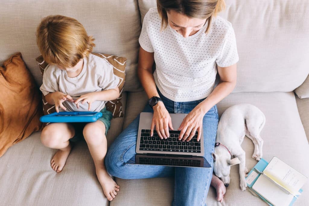 woman working with child next to her and dog. best side jobs for teachers to make extra money